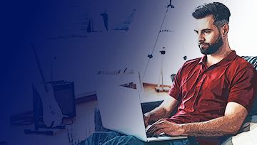 Man in red shirt working on laptop at home, highlighting a stable remote work setup powered by reliable broadband.